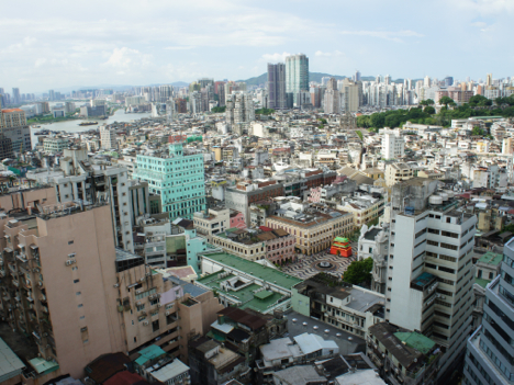 住宅や商業ビルが建ち並ぶマカオ半島の市街地。川を隔てた先が珠海市となる—本紙撮影